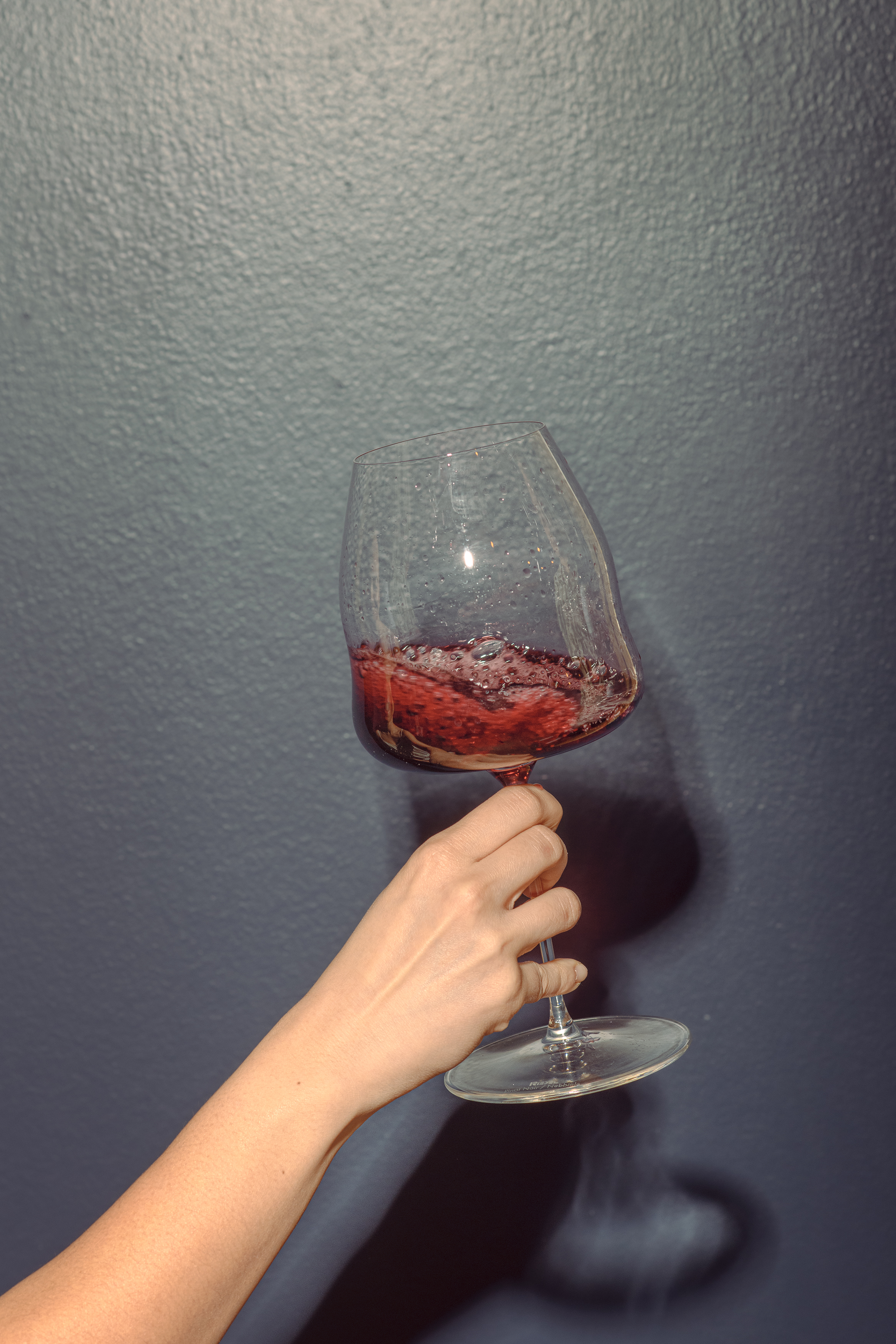 Hand holding glass of sparkling wine